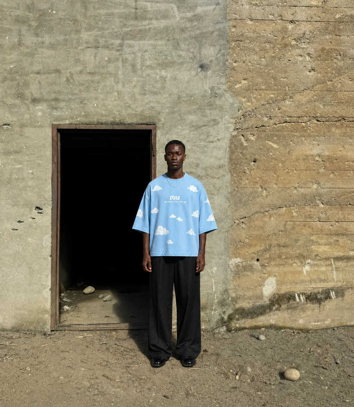 Cloud 9 T-shirt shown from the front in a weathered doorway
