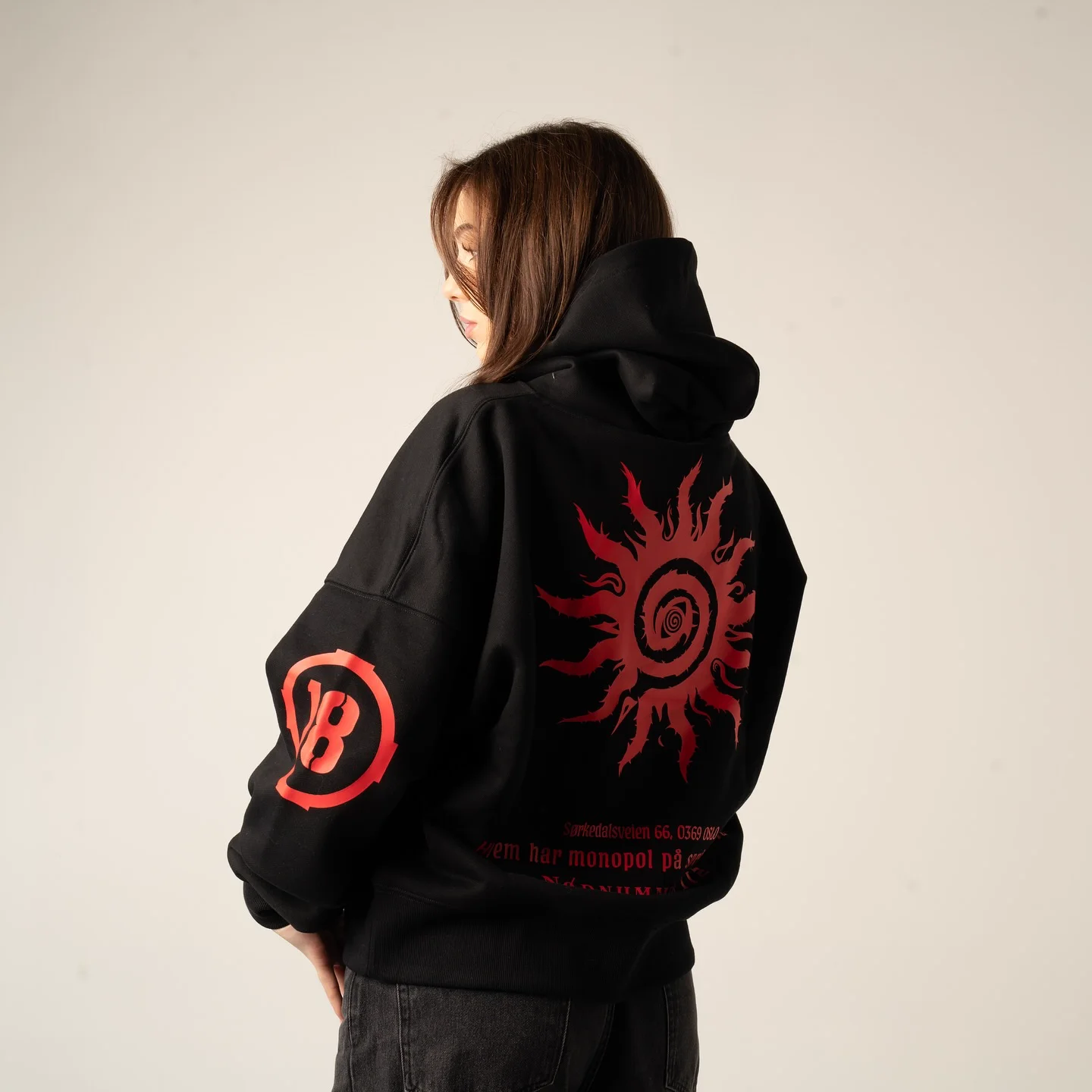 Back of the Voldsmonopol hoodie, the red sun across the shoulders and the circled 18 emblem on the sleeve